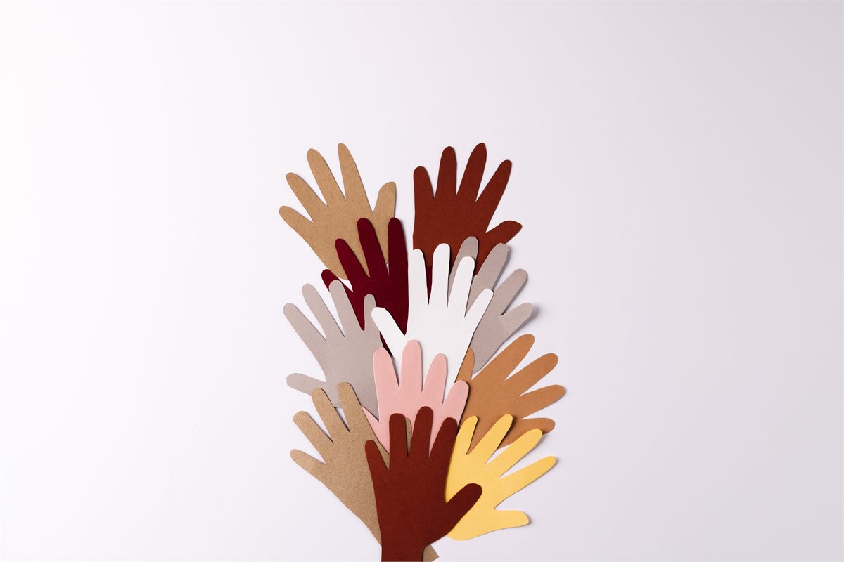Layered paper hands reaching upward, suggesting community, support and the social forces that shape how people move.